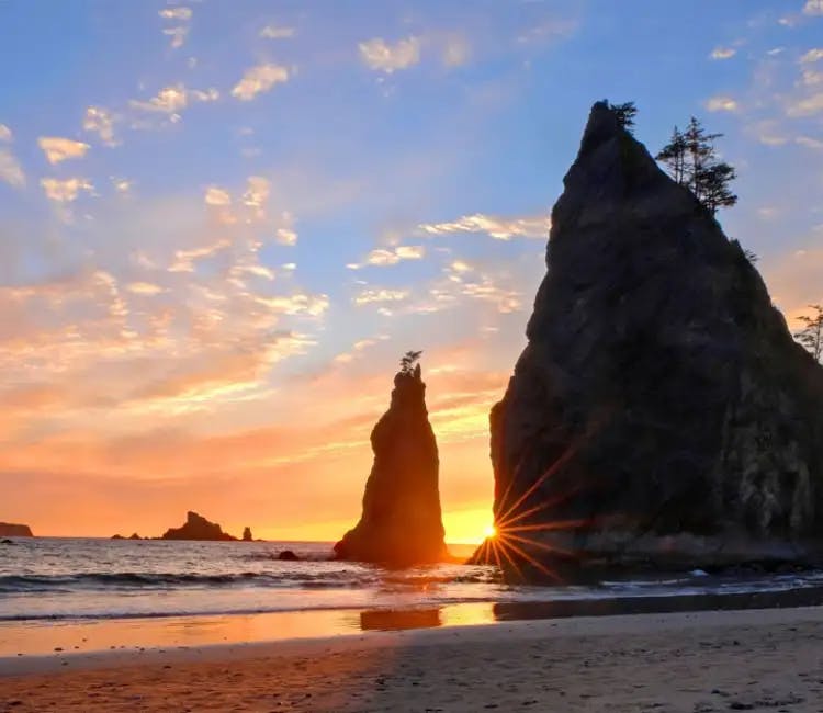 Sharp rock with a sunset in the background in La Push, Rialto beach